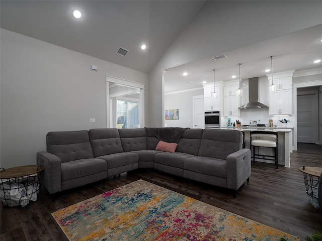 living room featuring dark wood-type flooring and high vaulted ceiling