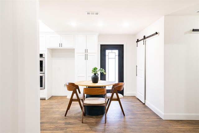 foyer entrance with a raised ceiling, dark wood-type flooring, and french doors