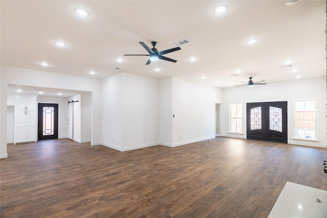 unfurnished living room featuring ceiling fan and dark hardwood / wood-style flooring