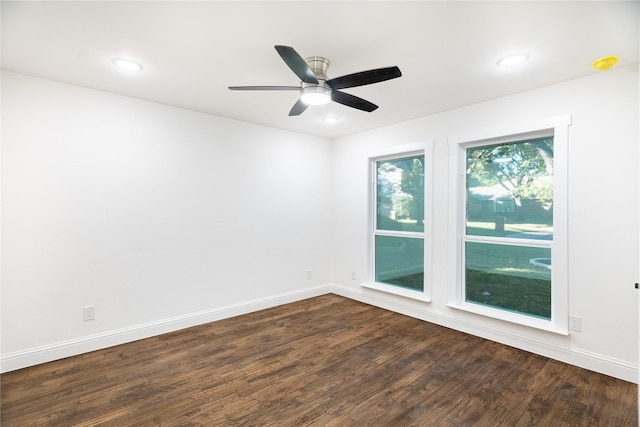 empty room featuring ceiling fan and dark wood-type flooring