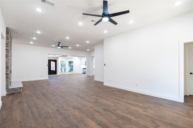 unfurnished living room featuring ceiling fan and dark wood-type flooring