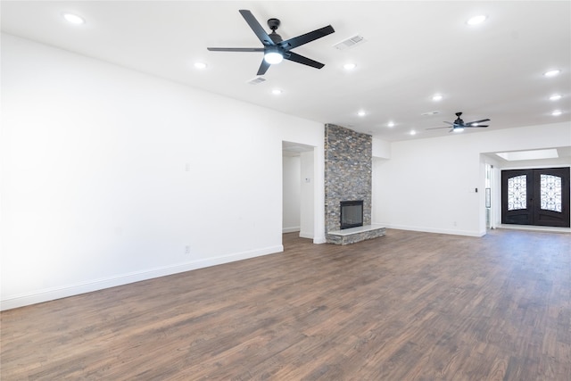 unfurnished living room featuring a fireplace and dark hardwood / wood-style floors