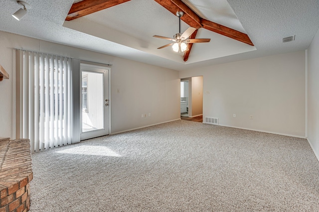 empty room with beamed ceiling, carpet, a textured ceiling, and ceiling fan