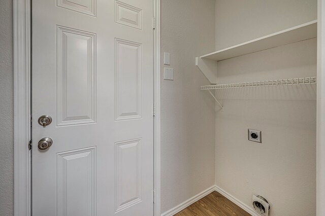 laundry room with hardwood / wood-style floors and electric dryer hookup