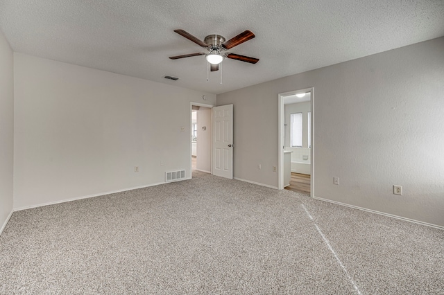 unfurnished room featuring carpet flooring, ceiling fan, and a textured ceiling