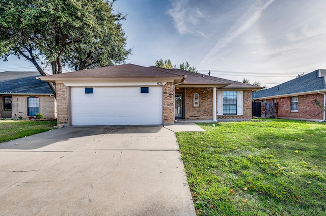 ranch-style home with a garage and a front lawn