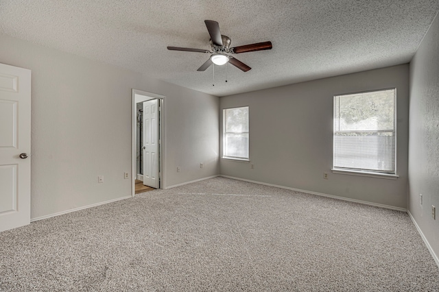 unfurnished room featuring ceiling fan, a textured ceiling, and light carpet