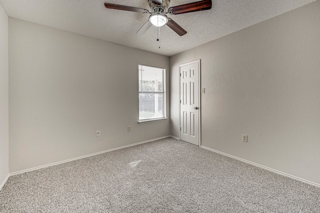 spare room with carpet flooring, ceiling fan, and a textured ceiling