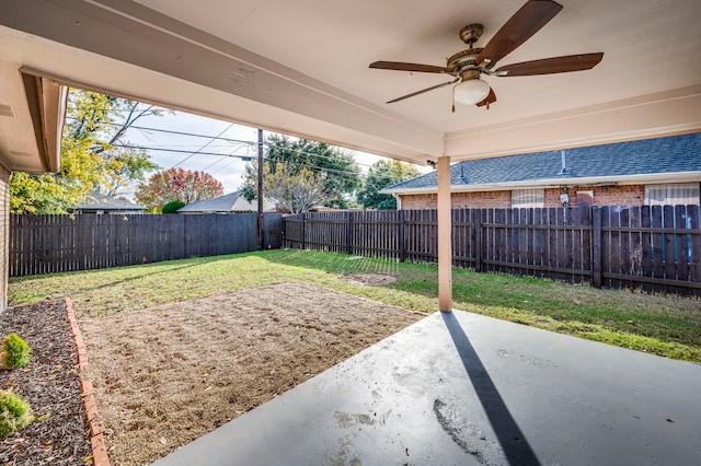 view of yard featuring ceiling fan and a patio