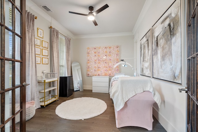 bedroom with crown molding, dark hardwood / wood-style floors, ceiling fan, and french doors