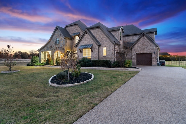 view of front of home with a lawn and a garage