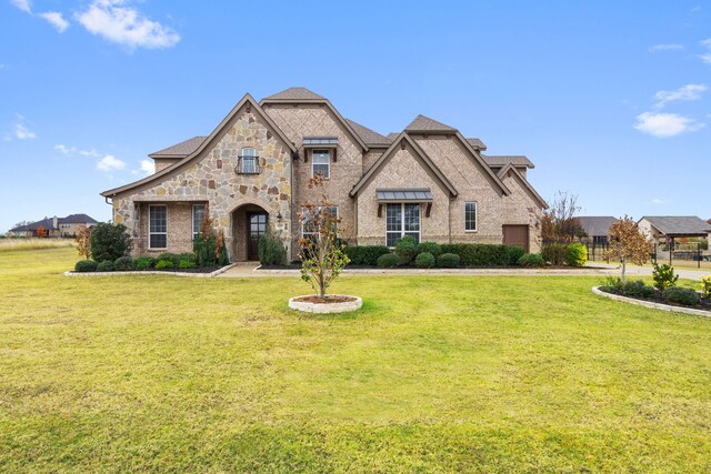 view of front of home with a lawn