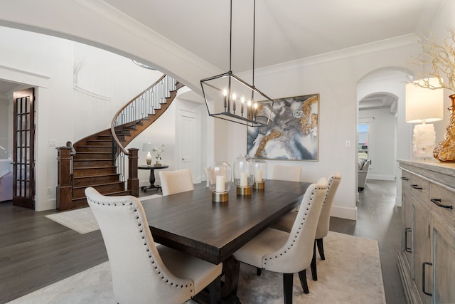 4509 Montalcino Blvd, Flower Mound, TX 75022 - dining space featuring dark wood-style flooring, a chandelier, arched walkways, stairs, and crown molding