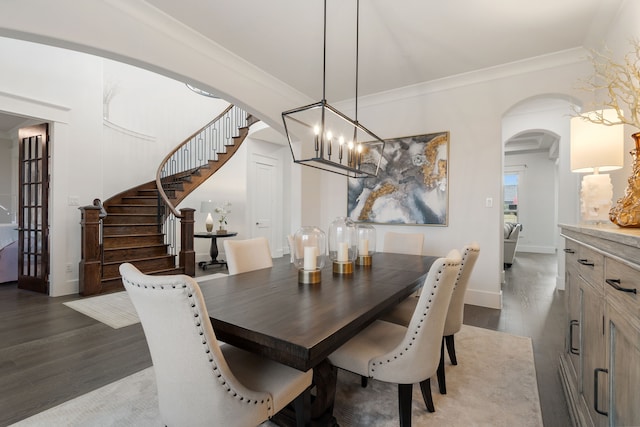 dining area featuring ornamental molding, wood-type flooring, and a chandelier