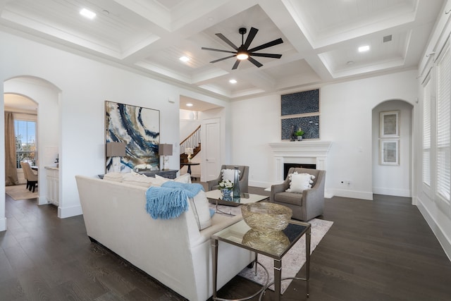4509 Montalcino Blvd, Flower Mound, TX 75022 - living room featuring arched walkways, ceiling fan, a fireplace, coffered ceiling, and beam ceiling