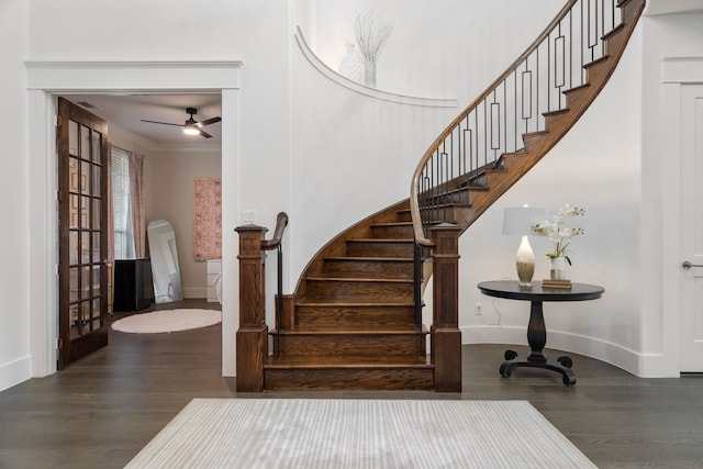 stairs featuring crown molding and hardwood / wood-style floors