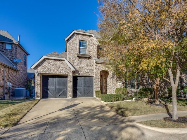 view of front of property featuring a garage and central air condition unit