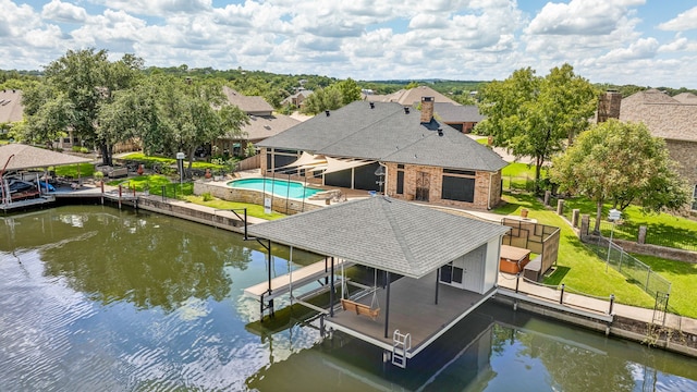 dock area with a yard and a water view