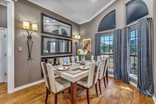 dining room with crown molding and hardwood / wood-style flooring