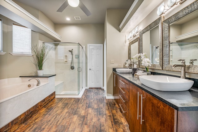 bathroom with hardwood / wood-style flooring, ceiling fan, vanity, and independent shower and bath