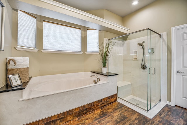 bathroom featuring plus walk in shower and hardwood / wood-style flooring