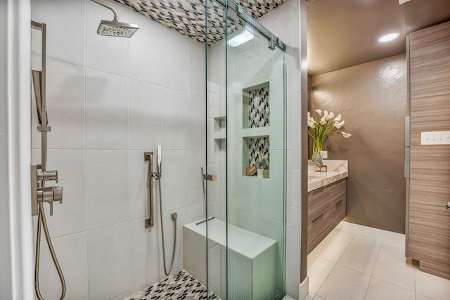 bathroom with tile patterned flooring, vanity, and a shower with shower door