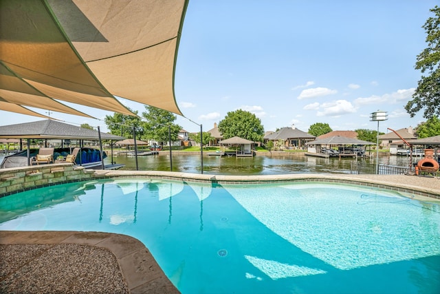 view of swimming pool with a water view and a dock