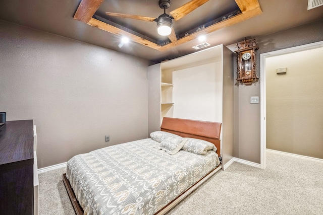 bedroom featuring carpet, a raised ceiling, and ceiling fan