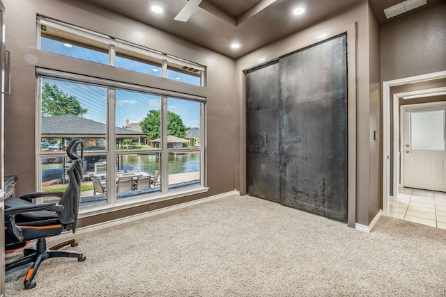 home office featuring a water view and carpet floors