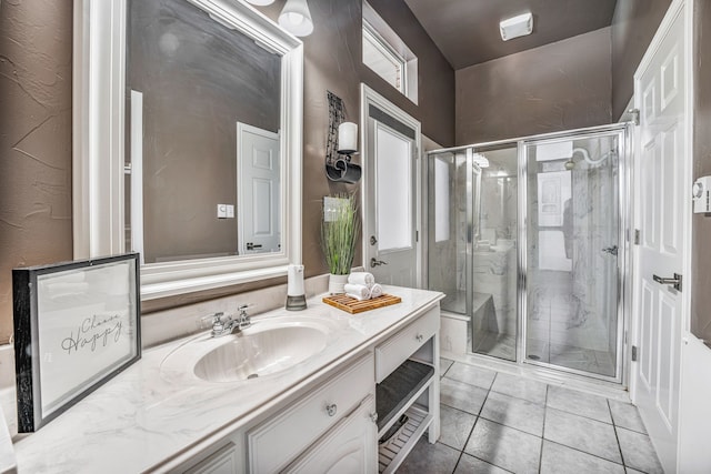 bathroom with tile patterned floors, vanity, and a shower with door