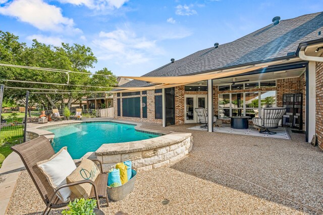 view of pool featuring a patio area and french doors