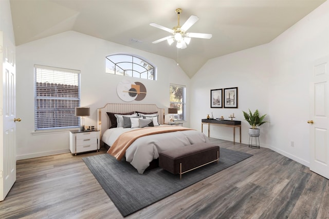 bedroom with hardwood / wood-style flooring, multiple windows, lofted ceiling, and ceiling fan