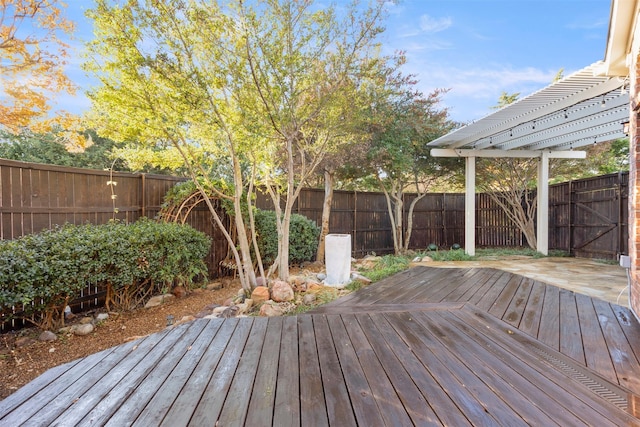 deck featuring a pergola and a fenced backyard