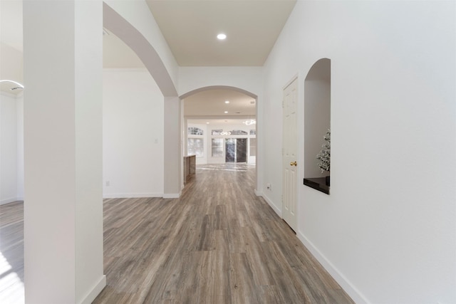 corridor with hardwood / wood-style floors