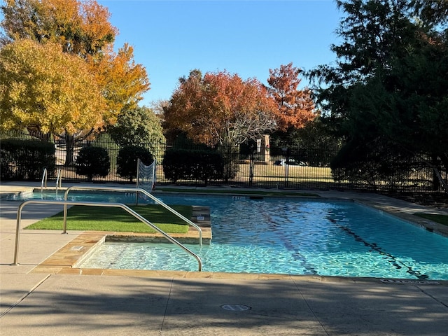 view of swimming pool with fence