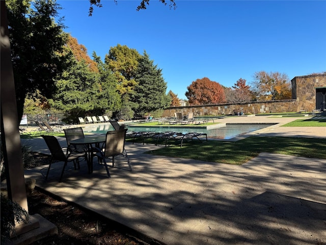 view of community featuring a pool and a patio area