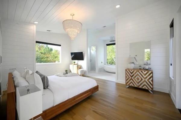 bedroom with wood-type flooring, wood ceiling, and a chandelier