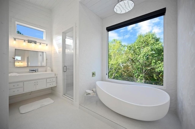 bathroom with plus walk in shower, vanity, a healthy amount of sunlight, and wooden ceiling