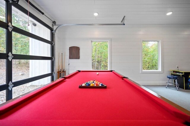 game room featuring a wealth of natural light, wooden walls, and billiards