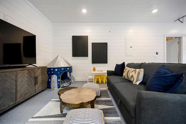 living room with electric panel and concrete floors