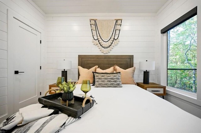 bedroom with wooden walls