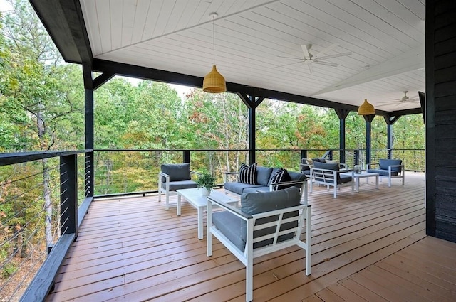 wooden deck with an outdoor hangout area and ceiling fan