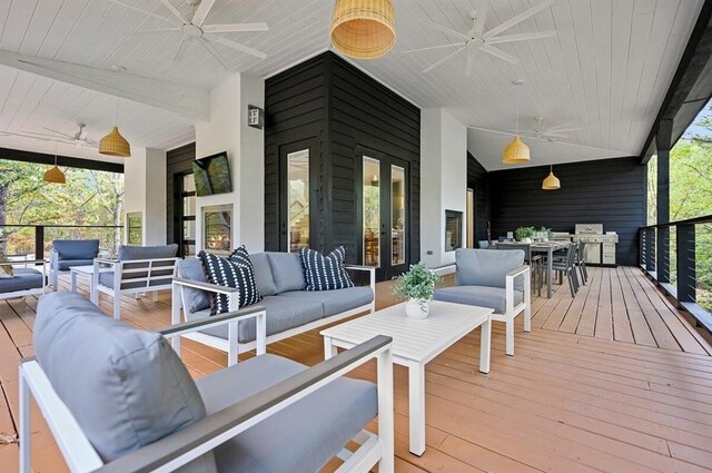 wooden deck with french doors and an outdoor hangout area