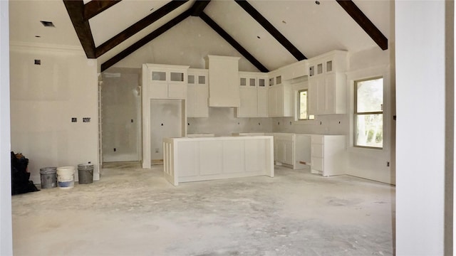 kitchen with white cabinets, custom exhaust hood, beamed ceiling, and high vaulted ceiling