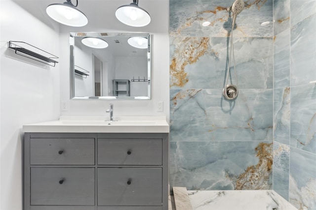 bathroom with vanity and tiled shower