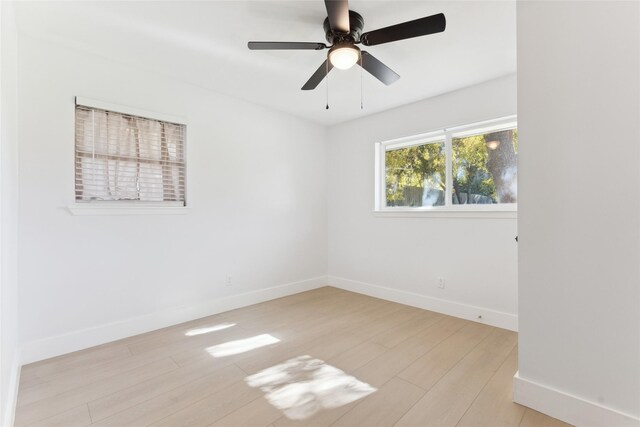 empty room featuring ceiling fan and light hardwood / wood-style floors