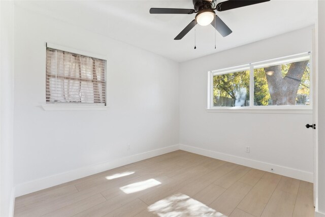 empty room with ceiling fan and light wood-type flooring