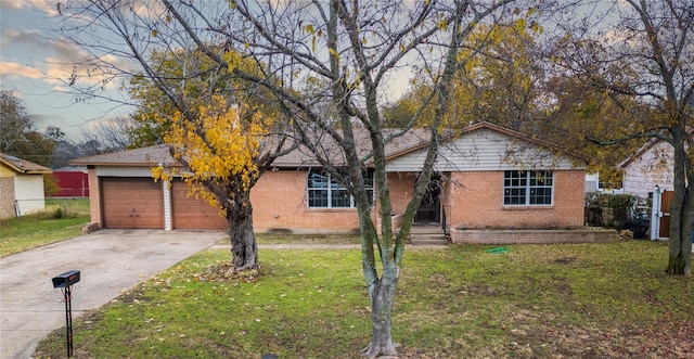 ranch-style home with a front lawn and a garage