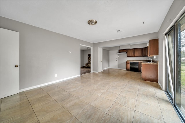 unfurnished living room with sink and light tile patterned flooring