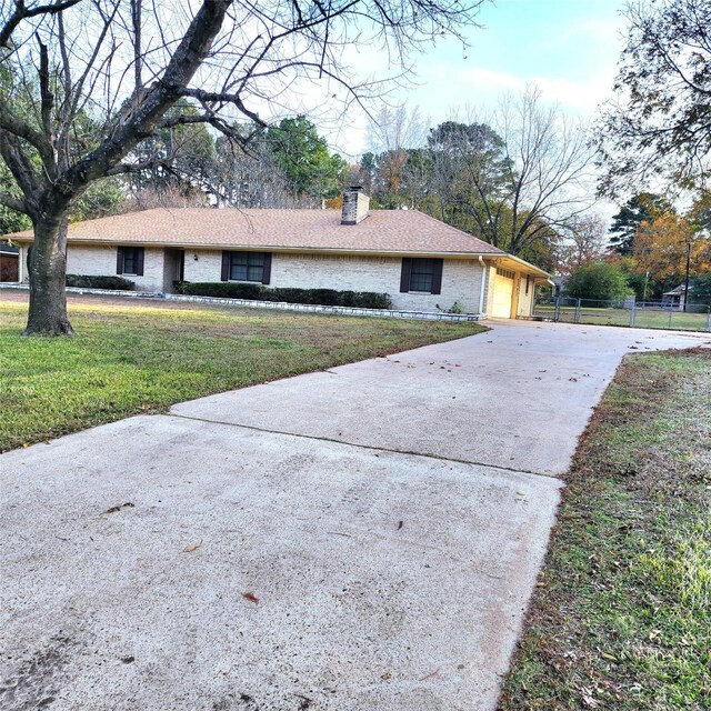 view of front of house with a front yard and a garage